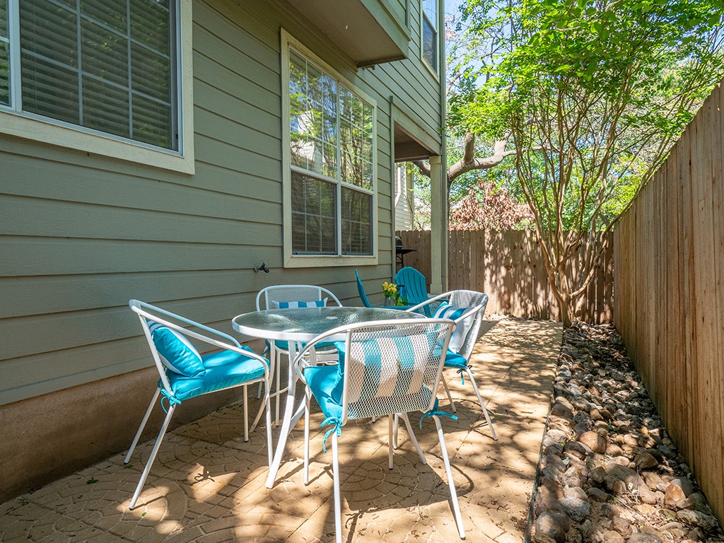 8518 Cahill Drive, Unit 47 Austin, TX 78729 - Photo 5 of 28 a patio with table and chairs and potted plants