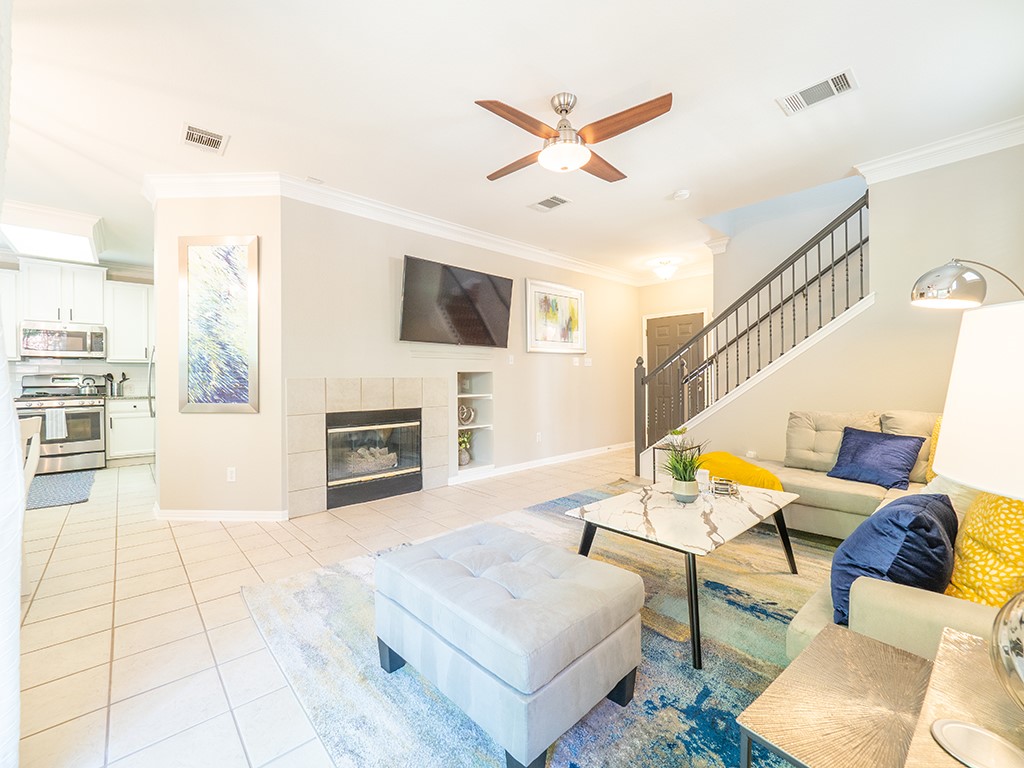 8518 Cahill Drive, Unit 47 Austin, TX 78729 - Photo 9 of 28 a living room with furniture a fireplace and a flat screen tv