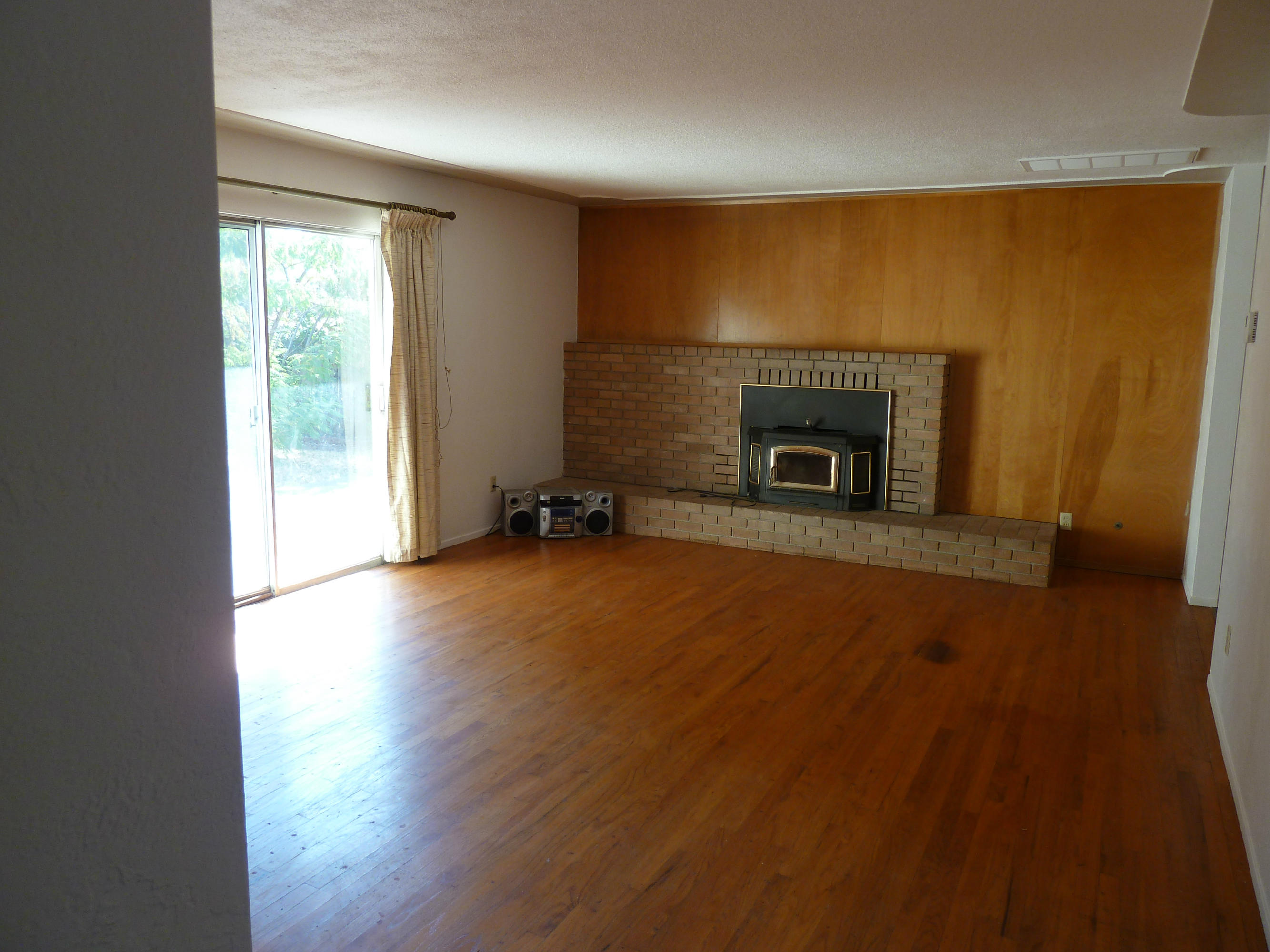 2755 Irwin Road Redding, CA 96002 - Photo 14 of 35 wooden floor fireplace and windows in an empty room