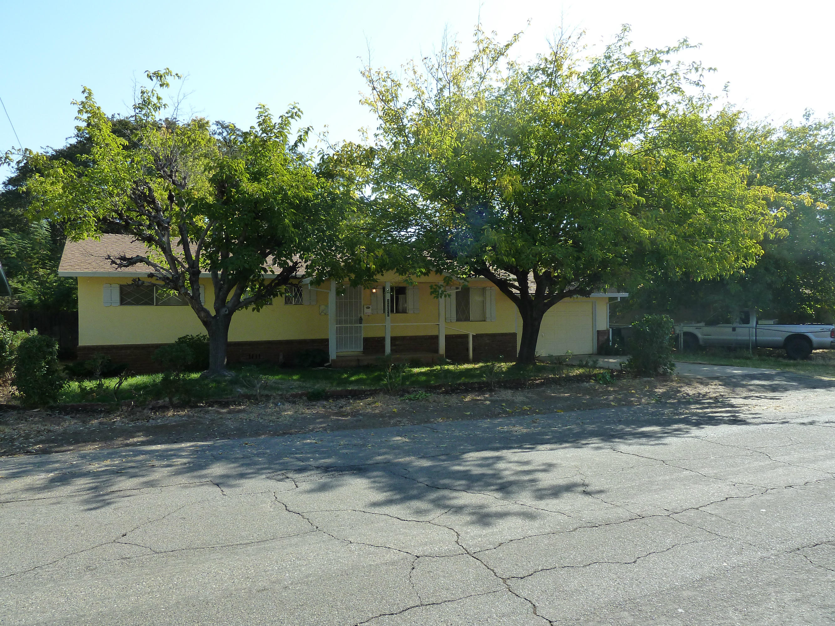 2755 Irwin Road Redding, CA 96002 - Photo 35 of 35 a view of a old house next to a yard with large trees