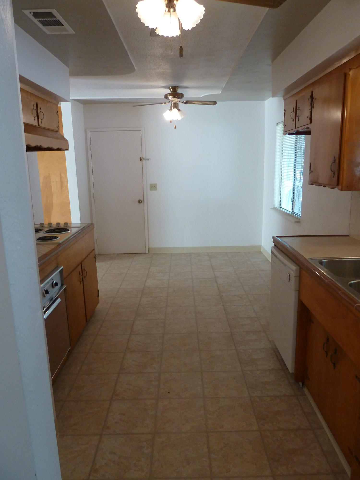 2755 Irwin Road Redding, CA 96002 - Photo 6 of 35 a view of a kitchen with a sink cabinet windows and a ceiling fan