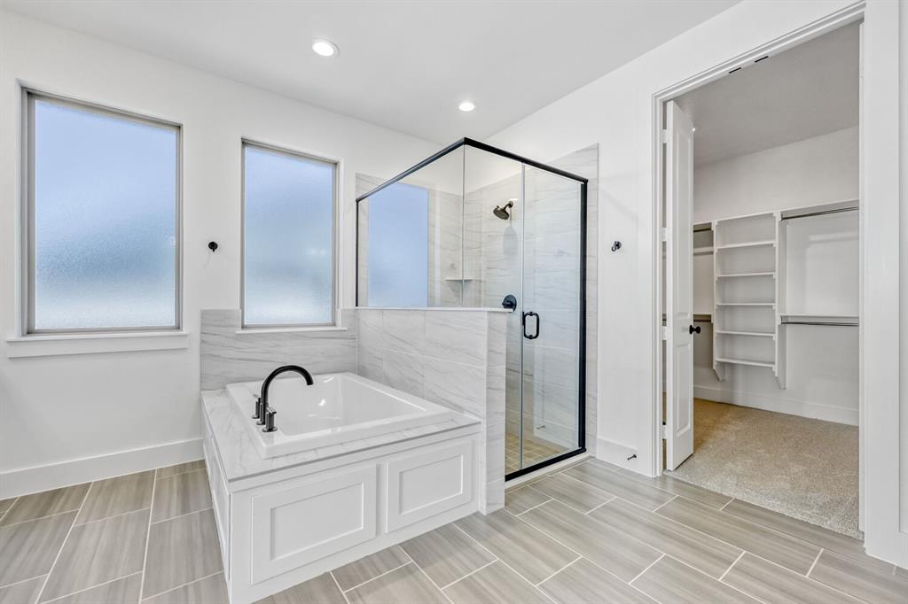 147 Derrett Lane Rhome, TX 76078 - Photo 17 of 28 Bathroom with a walk in closet, a stall shower, a bath, and recessed lighting