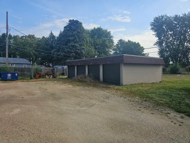 a view of a house with a yard and a garage
