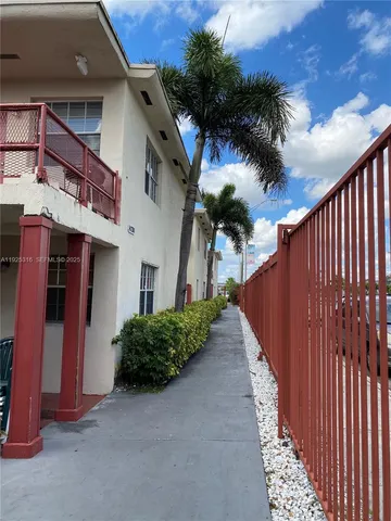 a view of a house with a small yard and plants