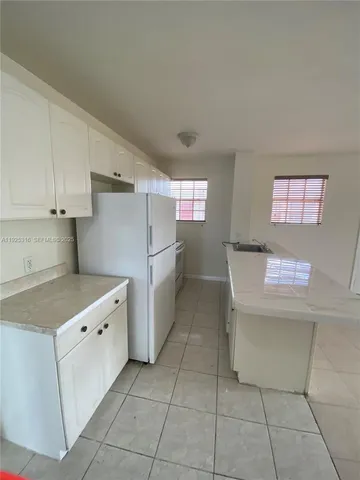 a kitchen with cabinets and white appliances