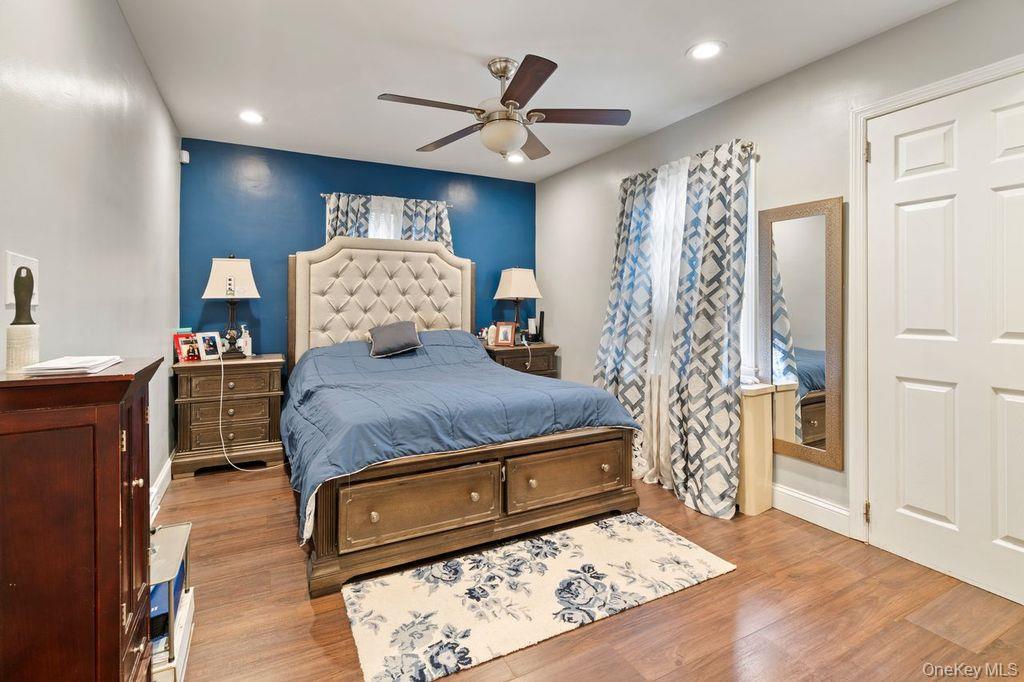 21 Jasper Street Valley Stream, NY 11580 - Photo 11 of 27 a bed room with a bed and a chandelier