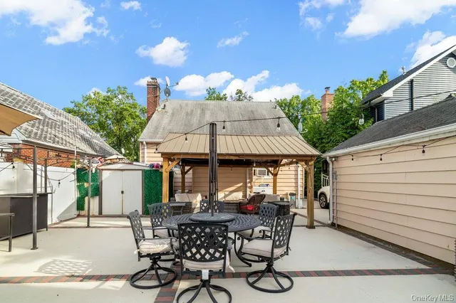 a view of a patio with table and chairs with wooden floor and fence