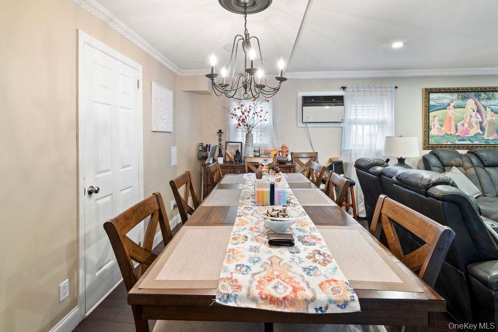 21 Jasper Street Valley Stream, NY 11580 - Photo 7 of 27 a view of a dining room with furniture a chandelier and wooden floor