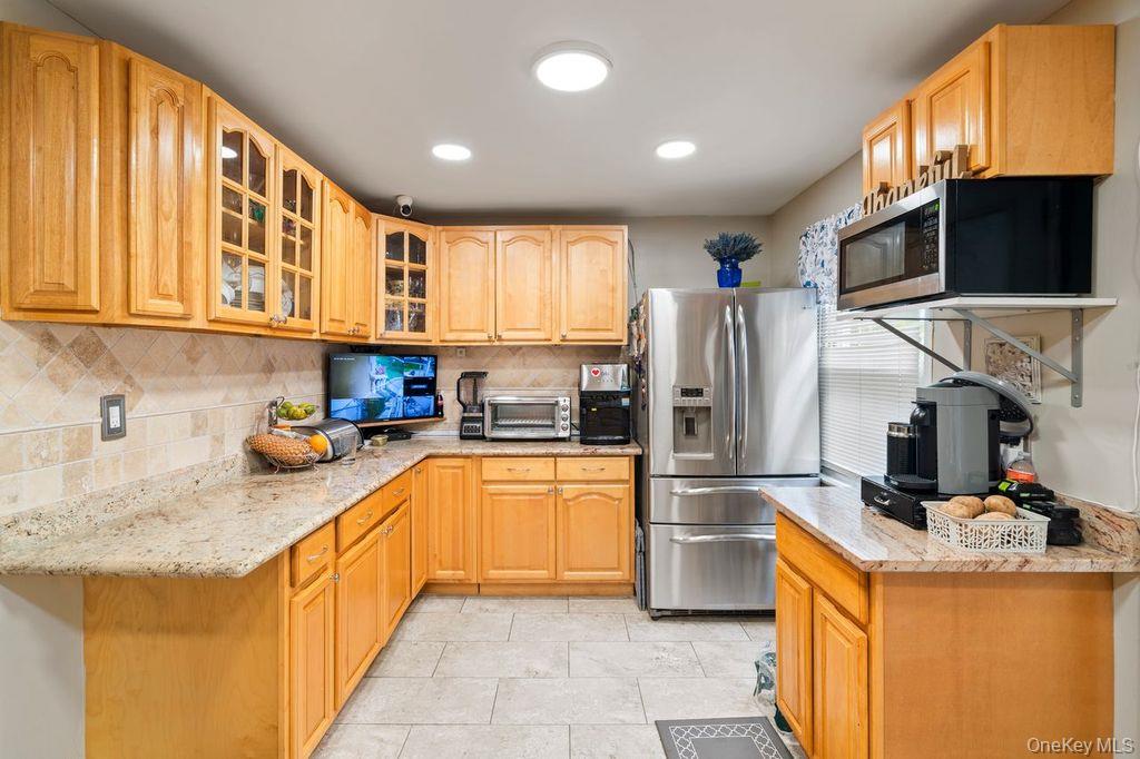 21 Jasper Street Valley Stream, NY 11580 - Photo 8 of 27 a kitchen with stainless steel appliances granite countertop a refrigerator a stove top oven a sink and dishwasher