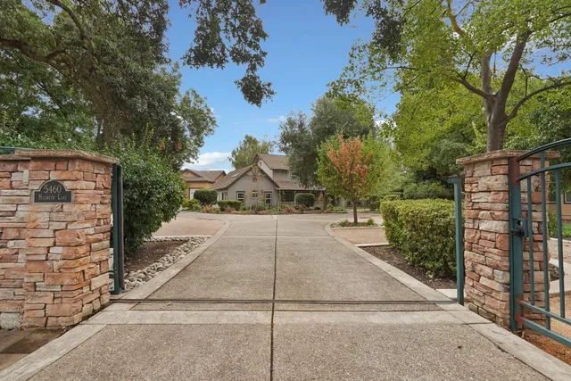 a view of a pathway with a wrought fence