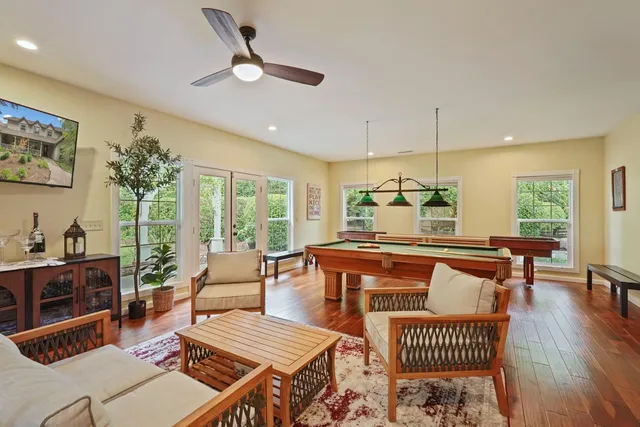 a bathroom with a toilet sink vanity and mirror