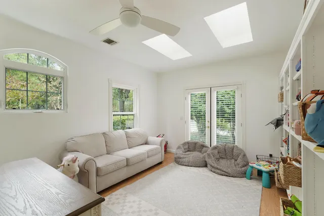 a bathroom with a granite countertop sink mirror and a large window