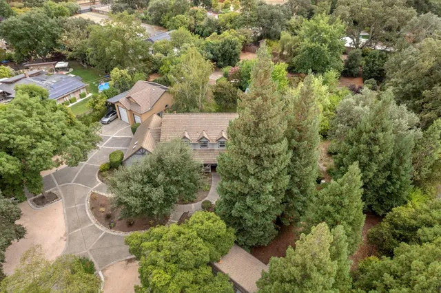 an aerial view of a house with yard