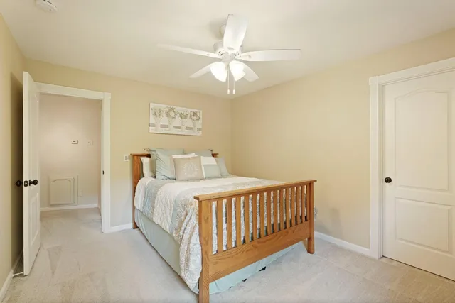 a view of a tennis ground with large trees