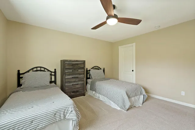 a view of a swimming pool with a yard and sitting area