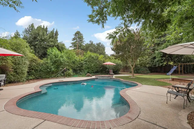 a spacious bedroom with a bed a couch and a large window