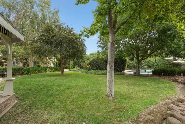a view of a pathway with a wrought fence