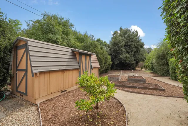 an aerial view of a house with a yard and trees