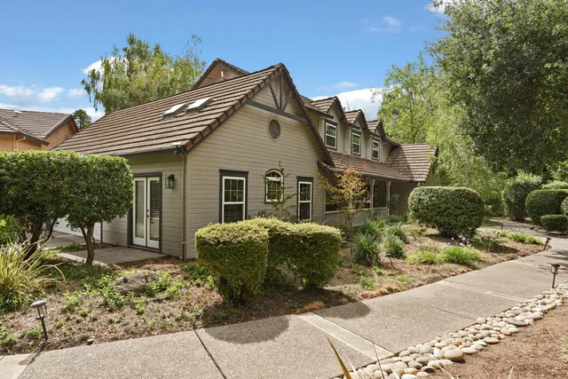 an aerial view of house with yard and outdoor seating