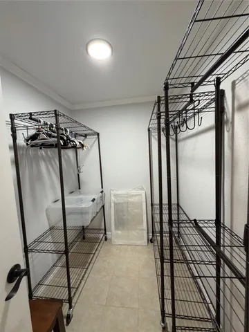 a view of a hallway with wooden floor and glass door