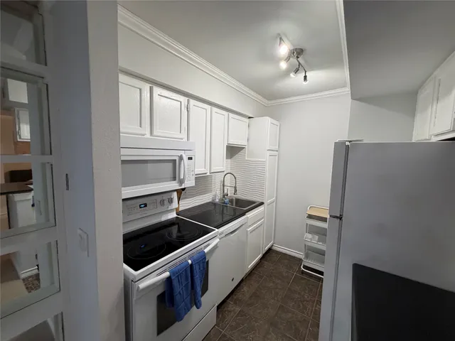 a kitchen that has a sink and a stove