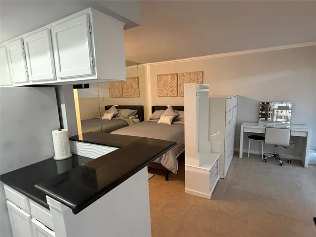 a kitchen with stainless steel appliances granite countertop a sink refrigerator and cabinets