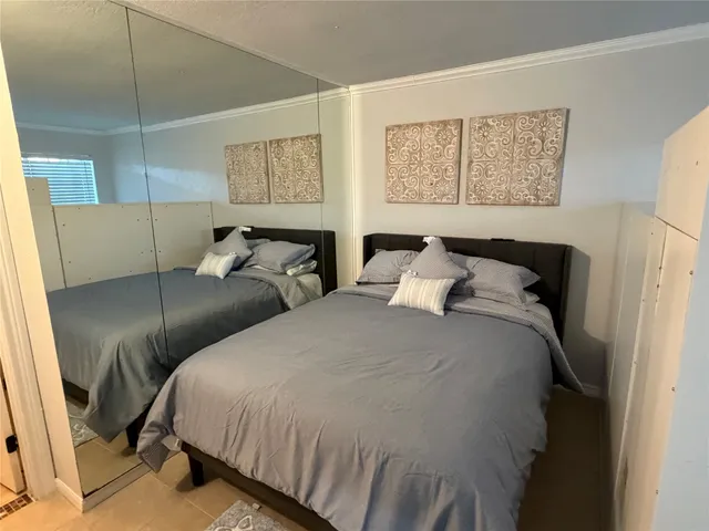 a bedroom with double bed and a window