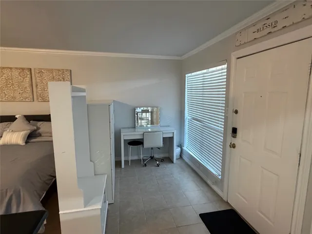 a view of a bedroom with a bed and a window