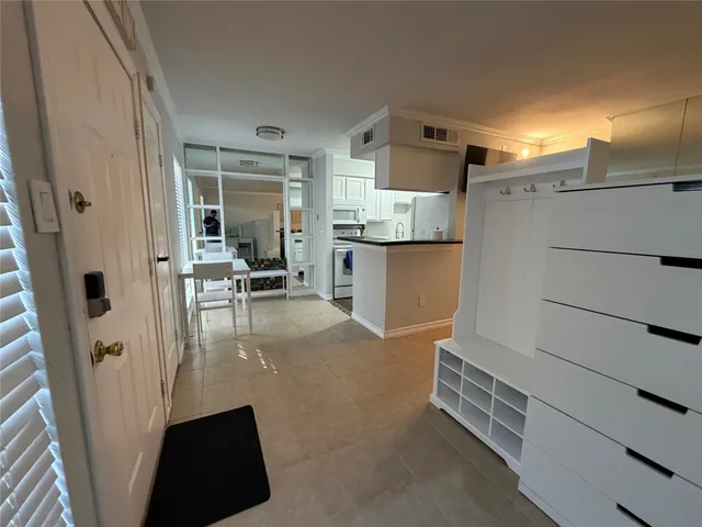 a view of kitchen with refrigerator and window