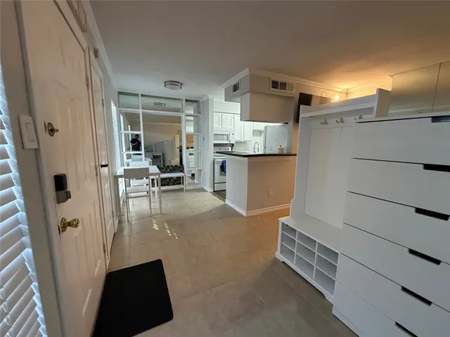 a view of kitchen with refrigerator and window