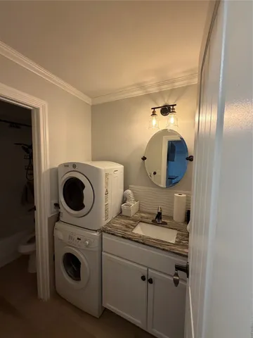 a bathroom with a sink and a washer dryer