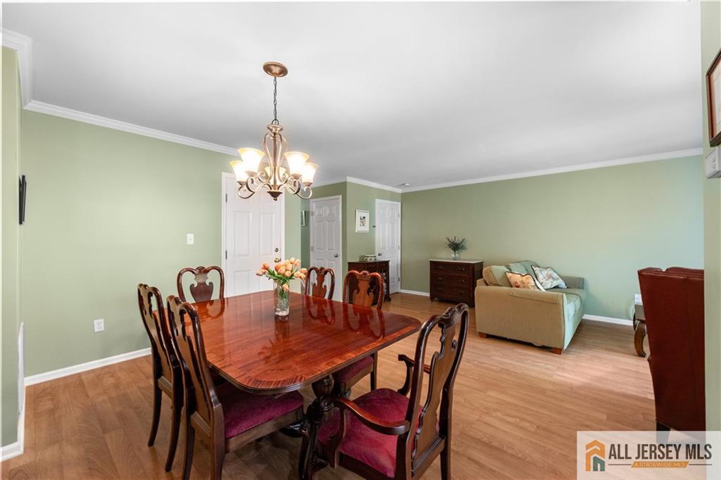 28 Garfield Way Princeton, NJ 08540 - Photo 14 of 39 a dining room with furniture a chandelier and wooden floor
