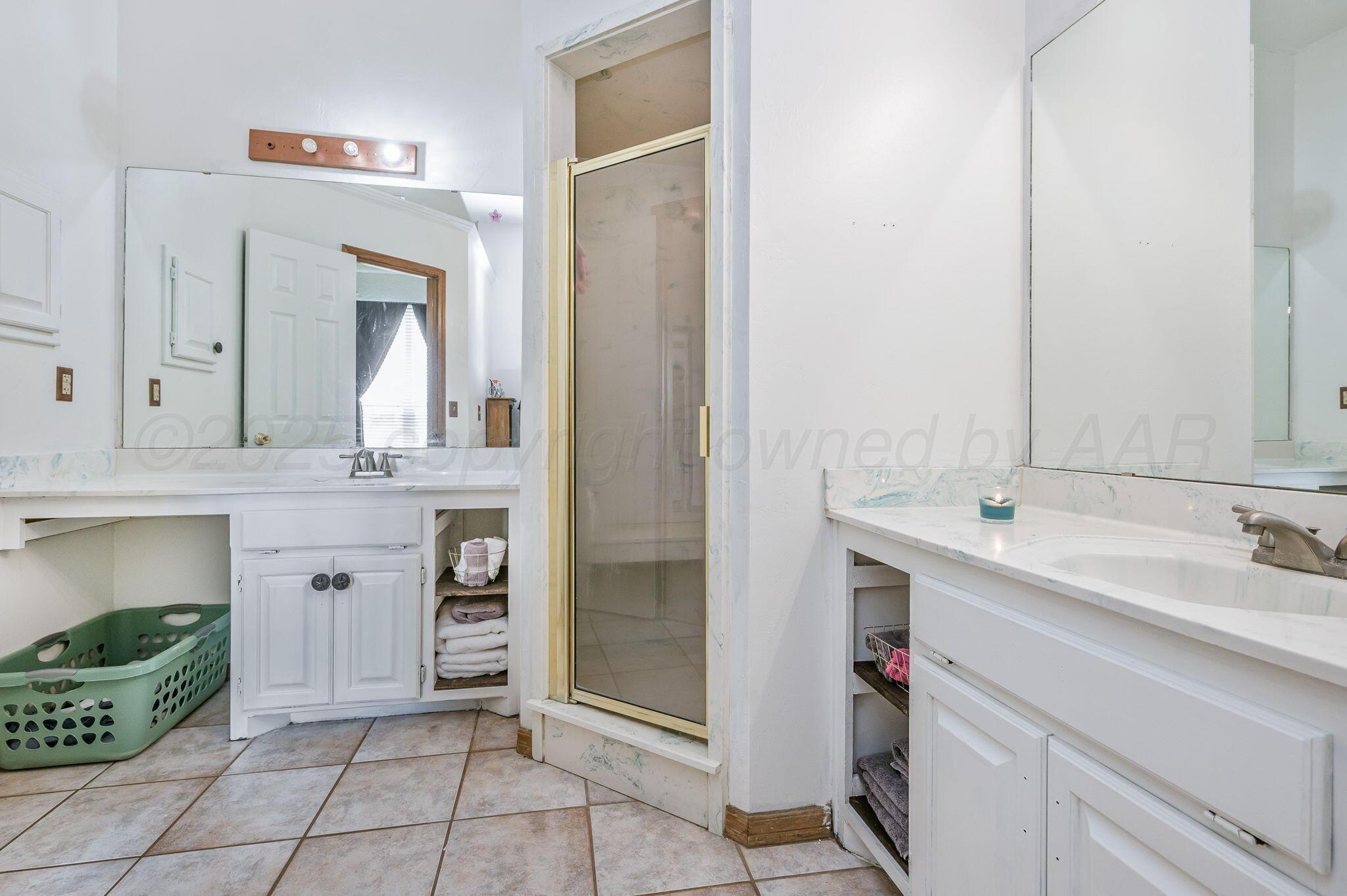 620 Lantana Road Bushland, TX 79124 - Photo 12 of 34 a spacious bathroom with a double vanity sink and a mirror