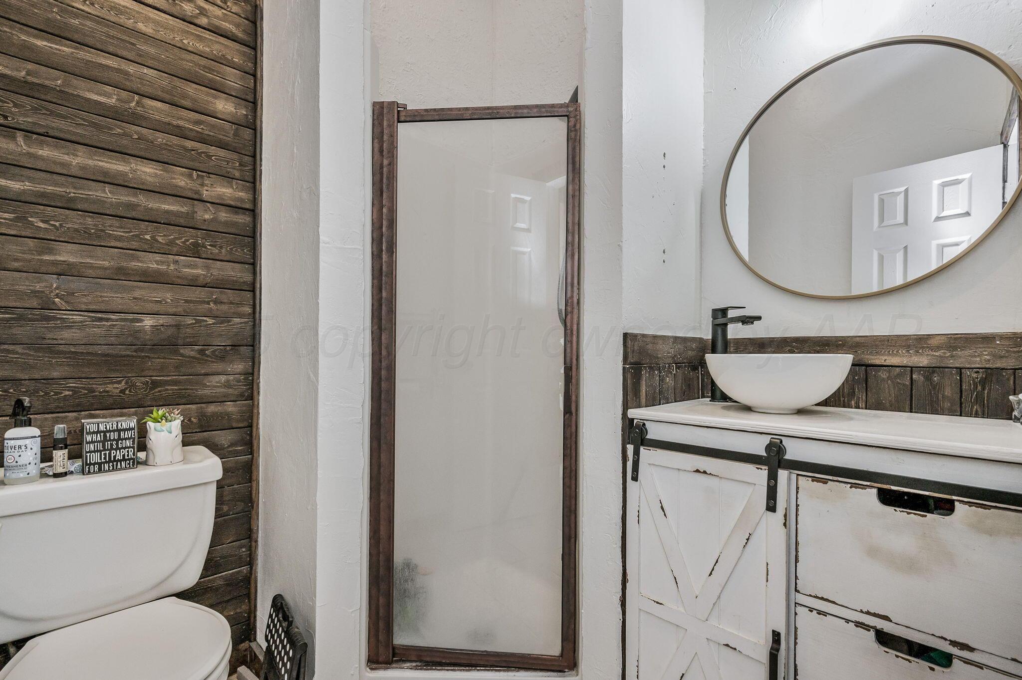 620 Lantana Road Bushland, TX 79124 - Photo 15 of 34 a bathroom with a toilet a sink and a mirror