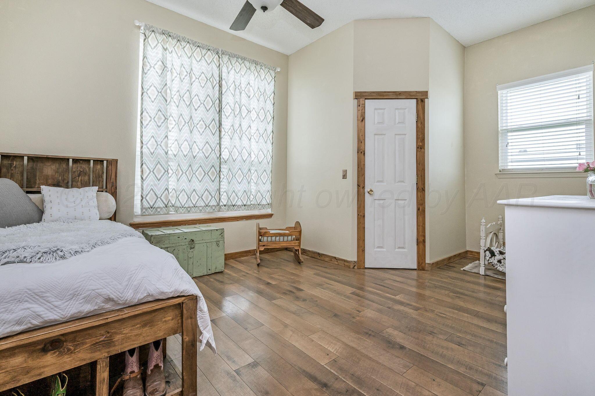 620 Lantana Road Bushland, TX 79124 - Photo 16 of 34 a spacious bedroom with a bed and a window