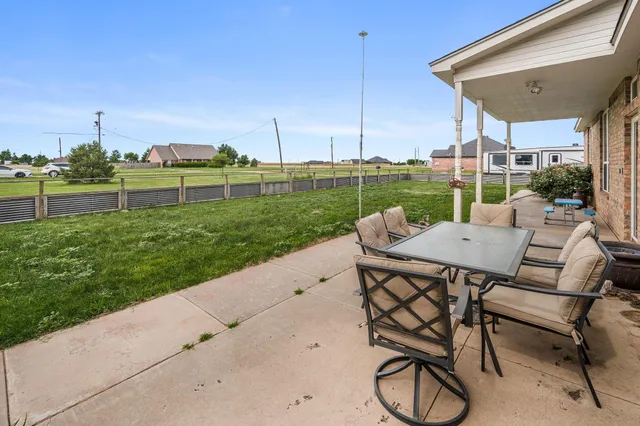 a view of yard with patio