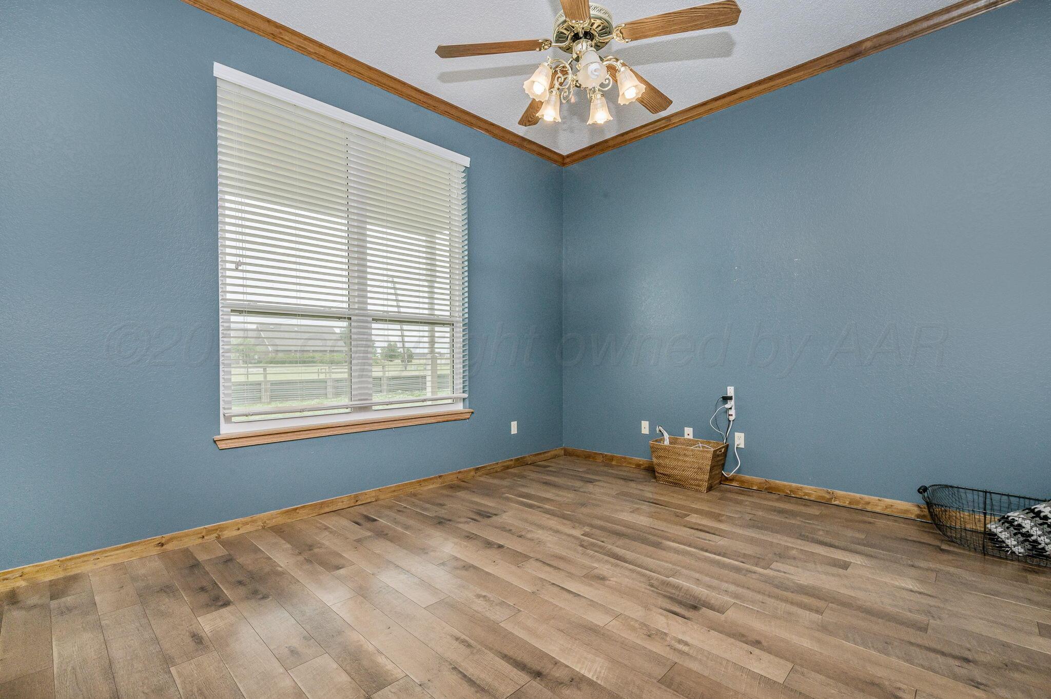 620 Lantana Road Bushland, TX 79124 - Photo 6 of 34 a bedroom with a bed and a chandelier