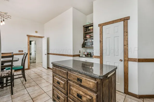 a kitchen with stainless steel appliances granite countertop a sink and a refrigerator