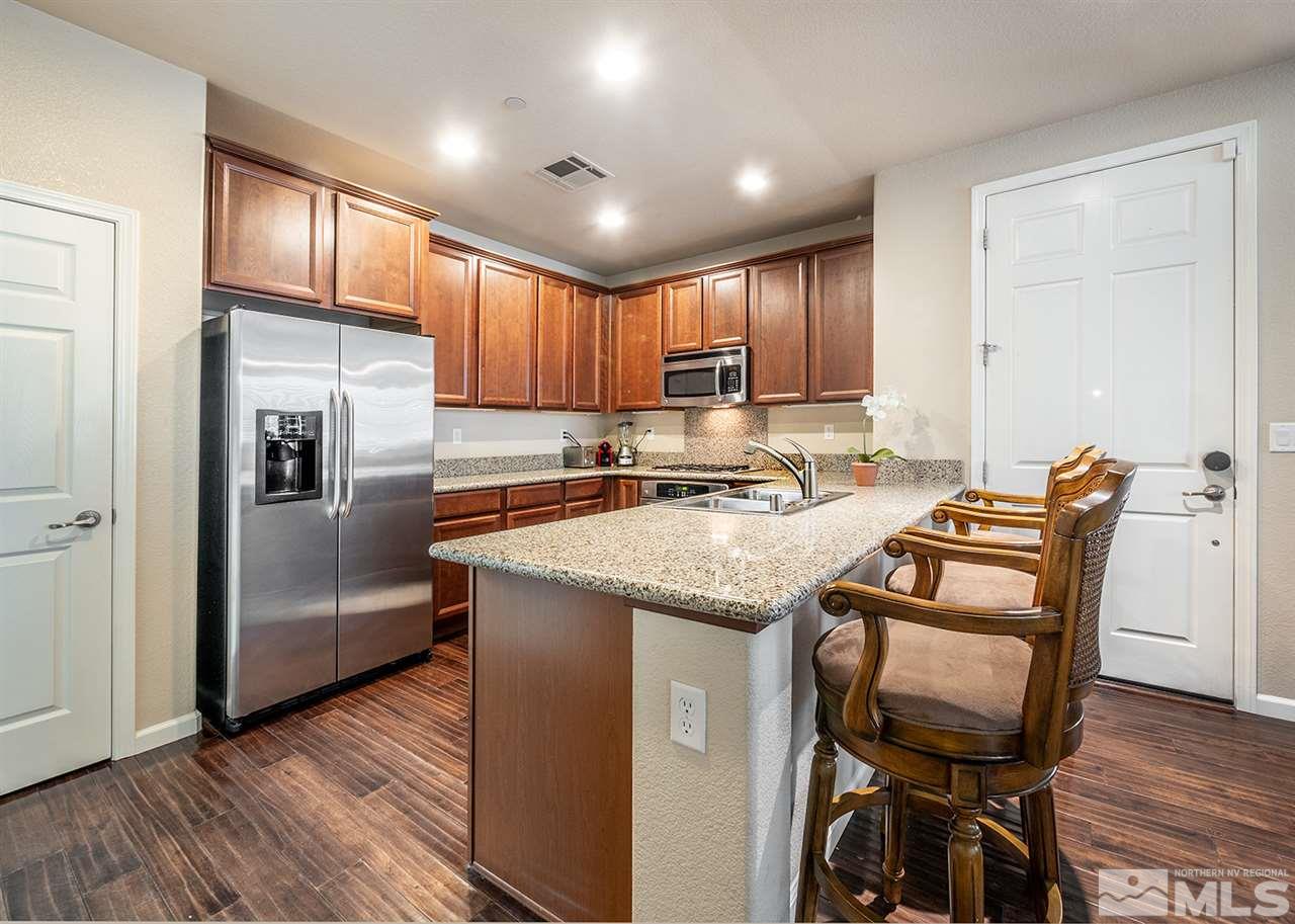 1955 Wind Ranch Road Reno, NV 89521 - Photo 11 of 18 a kitchen with granite countertop cabinets and refrigerator