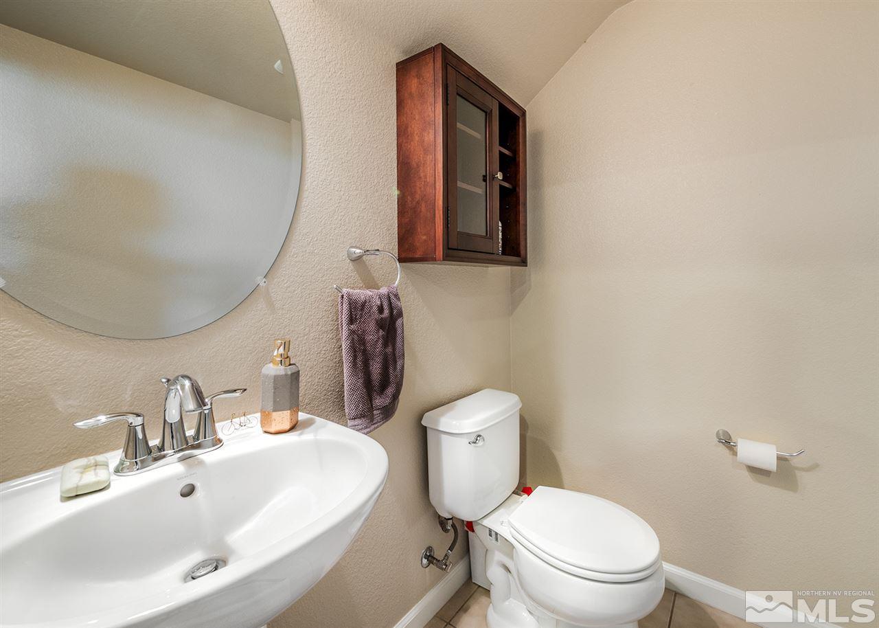 1955 Wind Ranch Road Reno, NV 89521 - Photo 13 of 18 a bathroom with a toilet sink and mirror