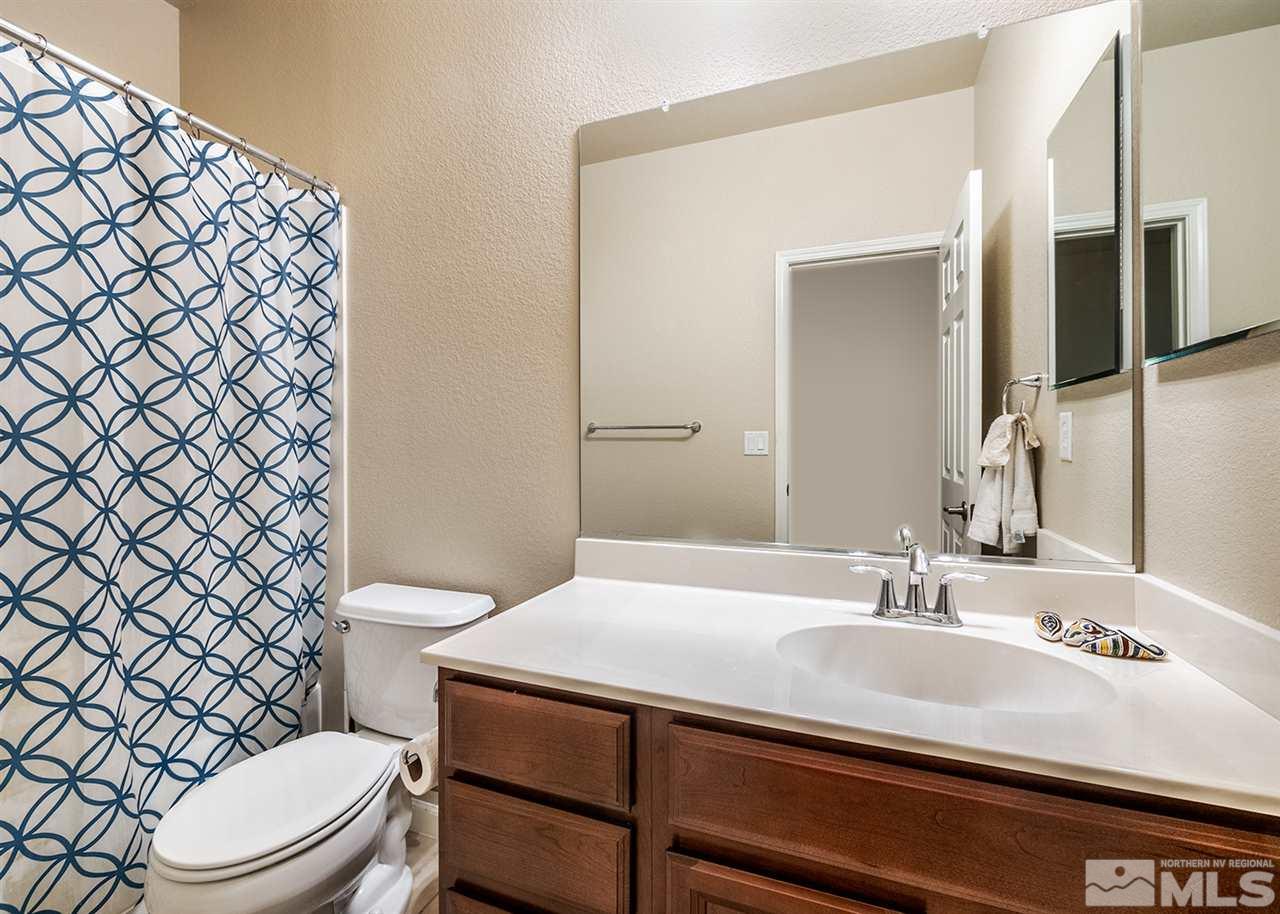 1955 Wind Ranch Road Reno, NV 89521 - Photo 18 of 18 a bathroom with a sink a toilet a mirror and shower