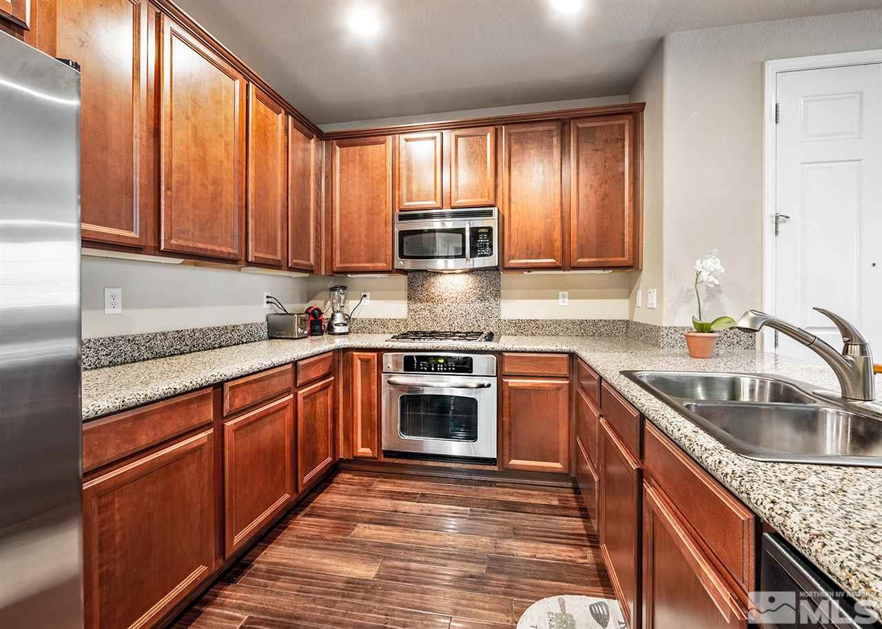 1955 Wind Ranch Road Reno, NV 89521 - Photo 10 of 18 a kitchen with granite countertop cabinets stainless steel appliances a sink and window