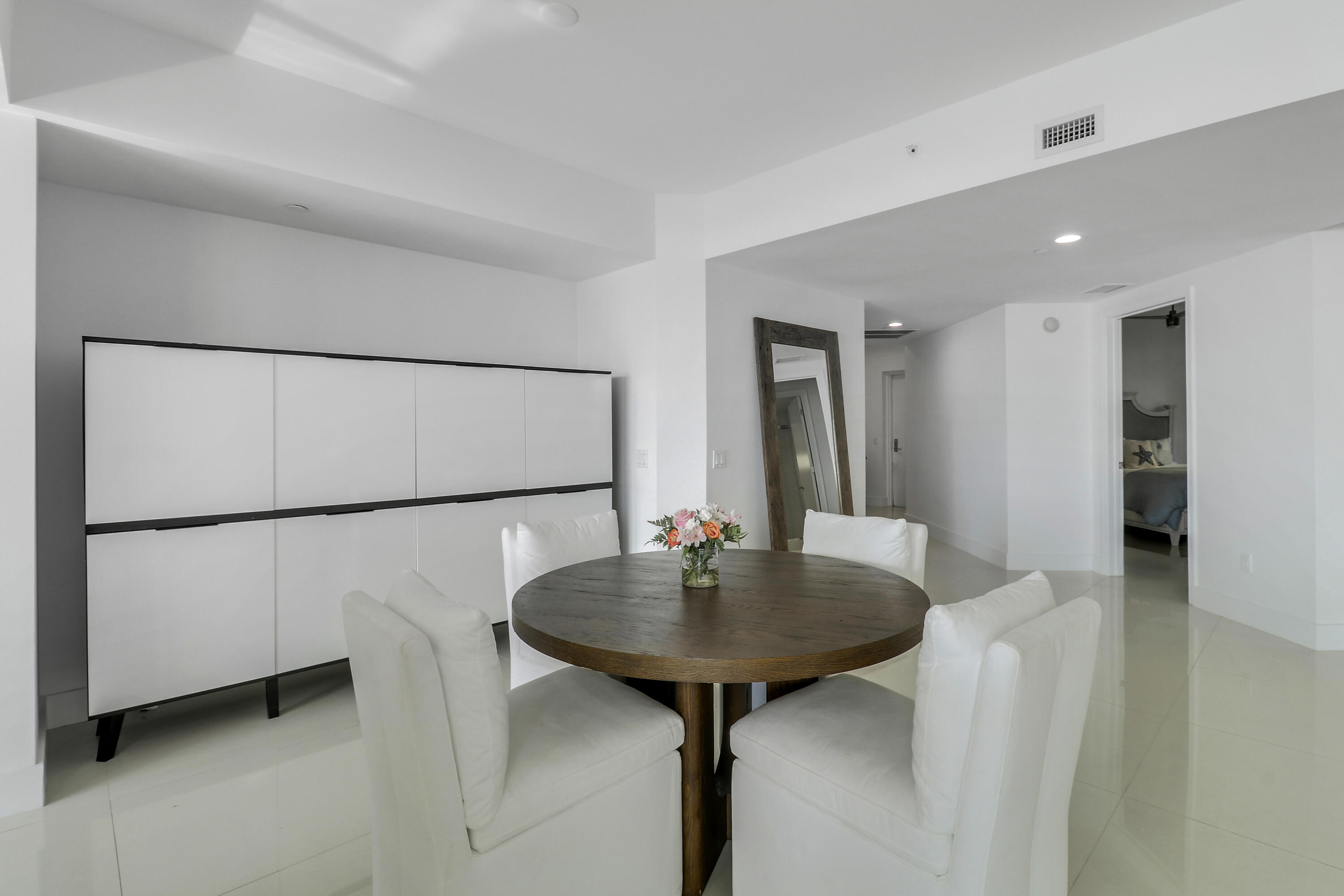 2640 Lake Shore Drive, Unit 307 Riviera Beach, FL 33404 - Photo 17 of 44 a kitchen with refrigerator and white cabinets