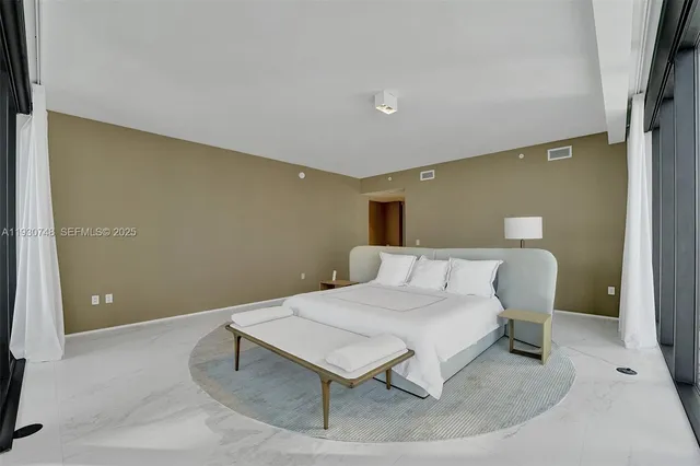 a bedroom with a bed and a table in it