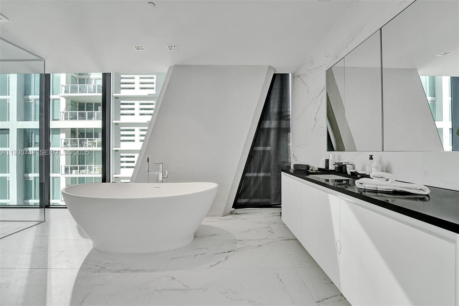 1000 Biscayne Boulevard, Unit 3902 Miami, FL 33132 - Photo 13 of 51 a bathroom with a bathtub and a sink