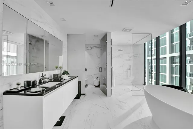 a bedroom with a bed and a large window