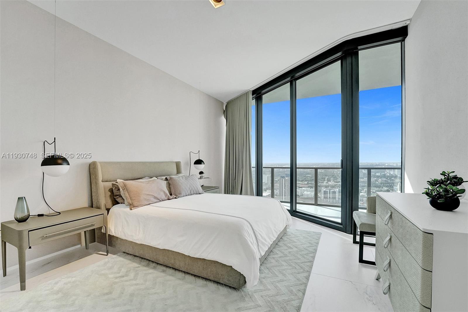 1000 Biscayne Boulevard, Unit 3902 Miami, FL 33132 - Photo 15 of 51 a bedroom with a bed and a large window