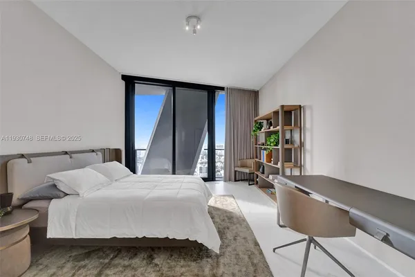 a bathroom with a toilet a sink a mirror and shower