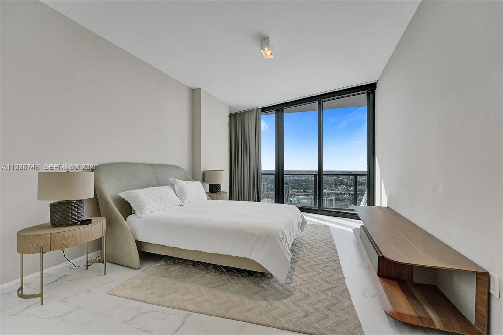 1000 Biscayne Boulevard, Unit 3902 Miami, FL 33132 - Photo 19 of 51 a bedroom with a bed and a window