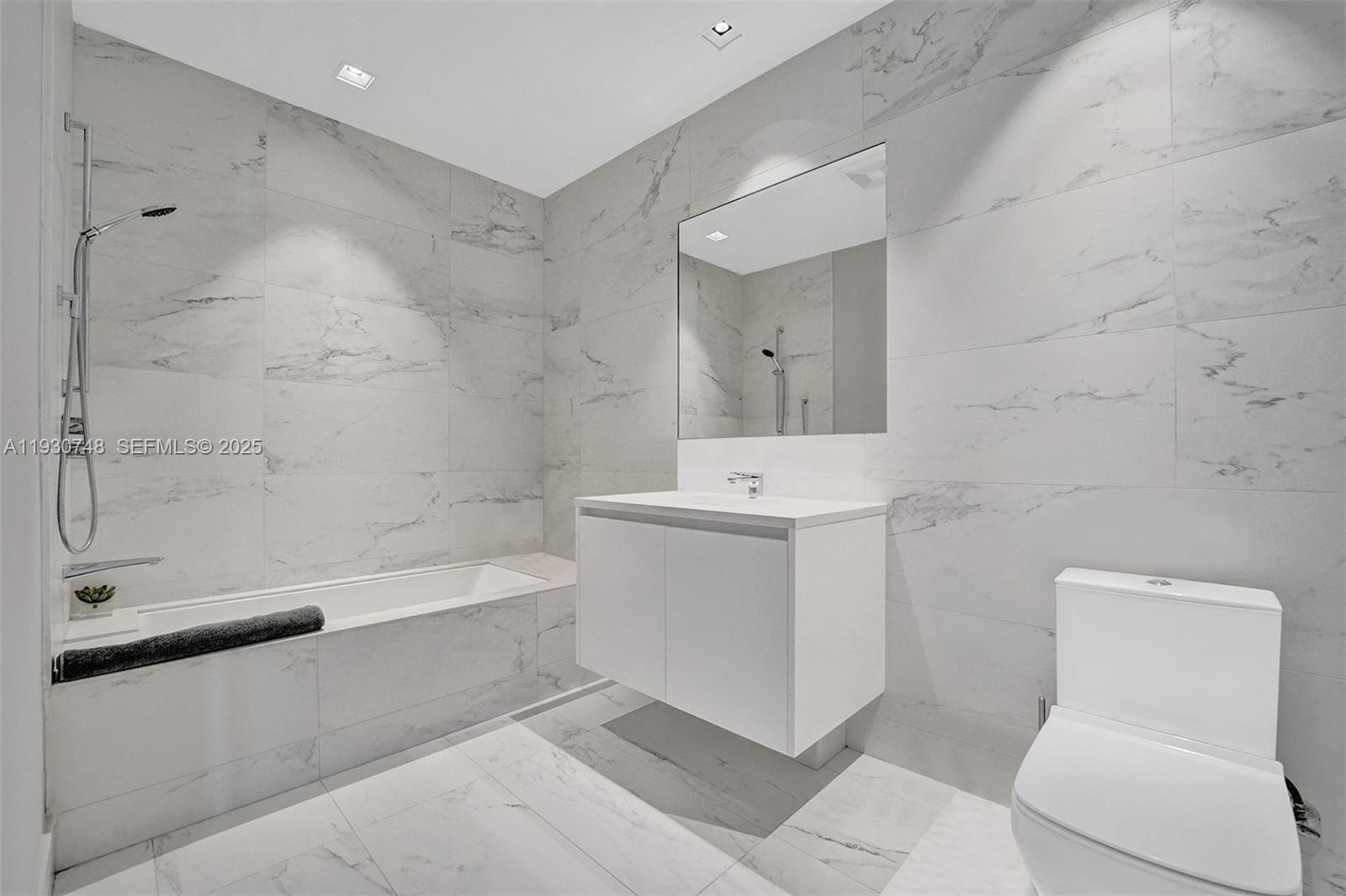 1000 Biscayne Boulevard, Unit 3902 Miami, FL 33132 - Photo 20 of 51 a bathroom with a sink a toilet and bathtub